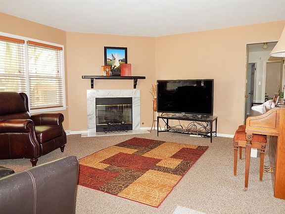 Living Room with Wood Burning Fireplace with gas starter.