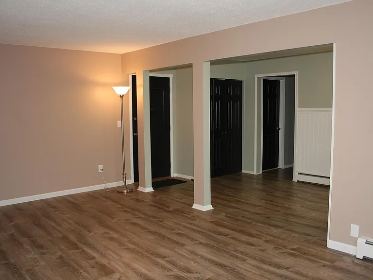 From living room looking toward dining area with bedrooms beyond.