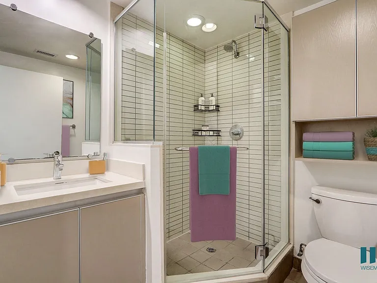Bathroom with Stand-Up Shower with Glass Door and Cabinet Storage
