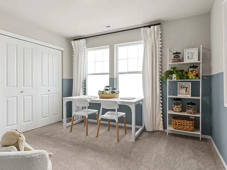 2nd bedroom with large windows and front yard views