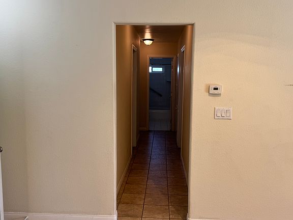 Hallway leading to all bedrooms and bathroom. Second bathroom is at the end of this hallway. view from living room.