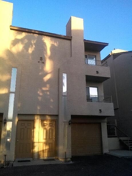 A view of the front door and attached garage