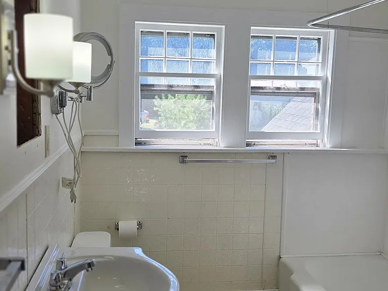 Bathroom With New Laminate Flooring, Vanity, Lighting and Washer/Dryer
