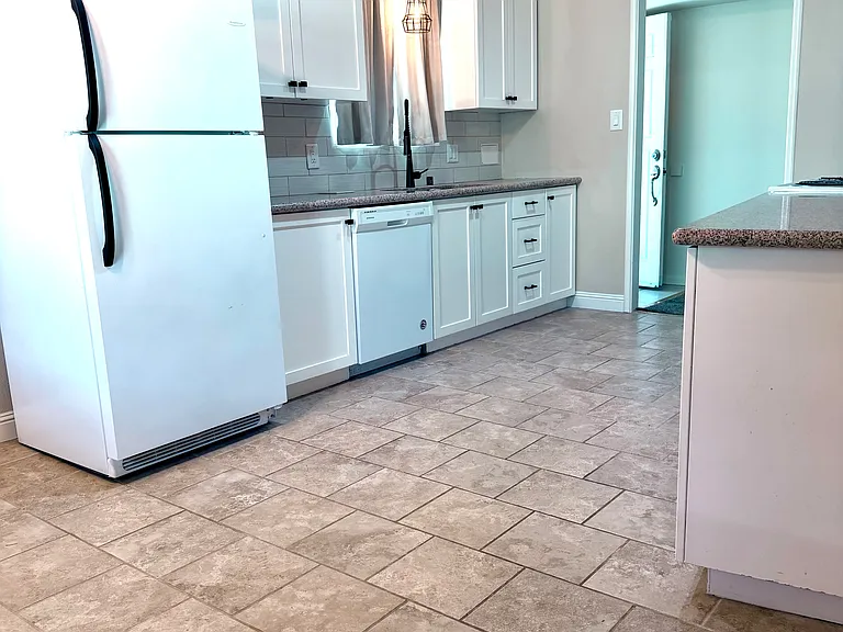 Recently remodeled kitchen with refrigerator.