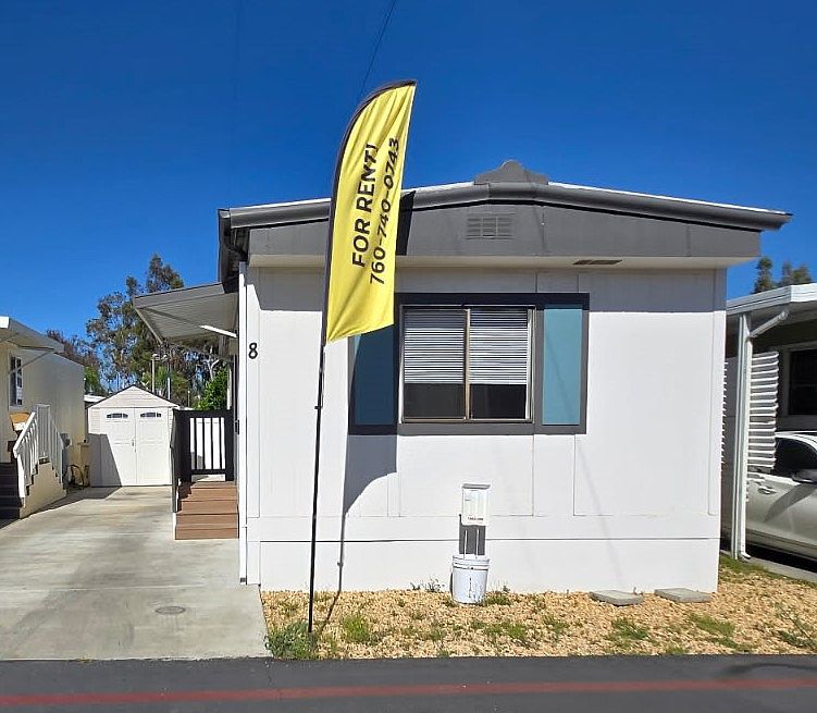 Neat and tidy mobile home featuring a well-maintained exterior, private entrance, and convenient parking. The property offers a comfortable outdoor space with minimal upkeep required.