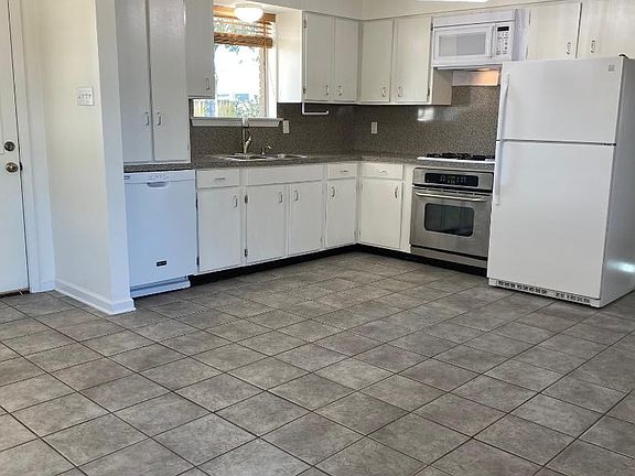Kitchen open to Family Room and Wet Bar. window over sink looks out to rear yard.