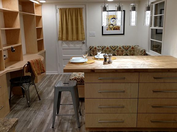 View from kitchen island to front door over built-in conversation area and library/desk