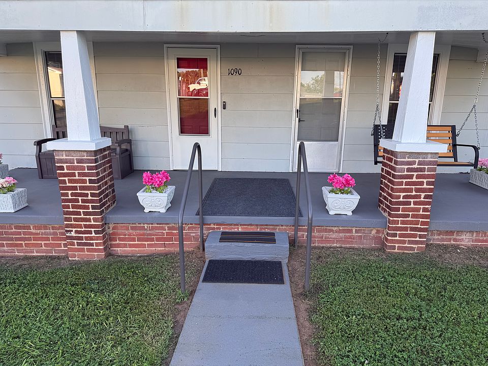 Large covered front porch with swing and bench