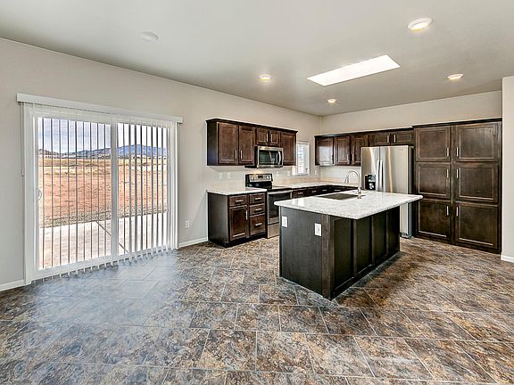 Kitchen & Dining - Solid wood cabinets & upgraded nickel hardware, upgraded stainless appliance package, center island, title back splashes, country farm sink with pull out faucet, skylight, recessed lighting.