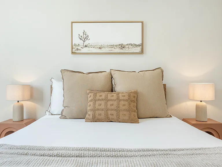 Bedroom 2 boasts a comfortable Queen-size bed, a wall-mounted smart TV, and a spacious mirrored reach-in closet!