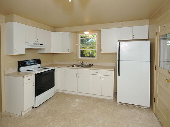 Kitchen with entry to side yard and grill area
