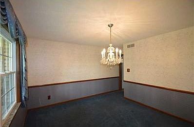 Dining Room. Chandelier stays in this spacious dining room adjacent to kitchen and views of front porch