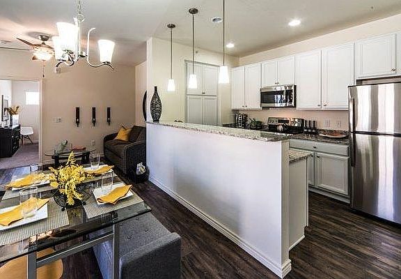 Living room, dining room, and kitchen have Shaw LPV flooring