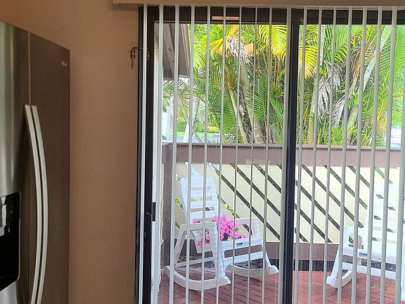 Kitchen view out to front patio. W&D in kitchen on right.