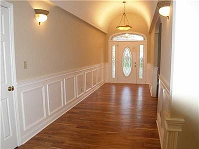 Entry. Elegant entry with hand scraped hardwoods, barreled ceiling, updated fixtures and wainscotting