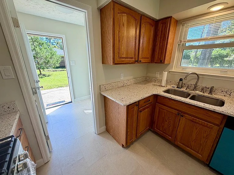 Kitchen looking through to laundry room/driveway entry door