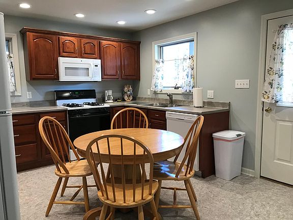 Large eat-in kitchen. Kitchen measures 12 ft x 14 ft, plus cabinets on 3 walls, east and north facing windows plus window in door for lots of light. Recessed lighting above all countertops for lots of light when the sun isn_t shining!