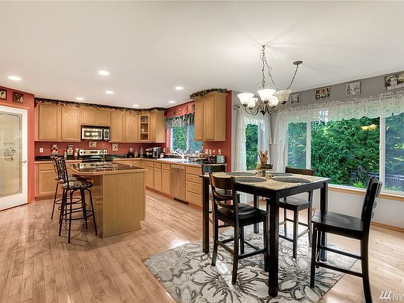 Spacious kitchen with eating nook. Notice the hardwood floors