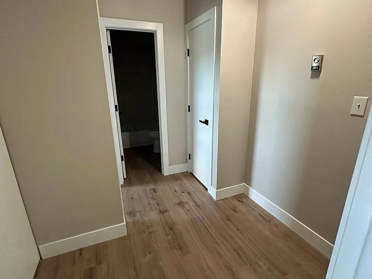 Upstairs hallway. Bathroom in far doorway. Linen closet on the right.