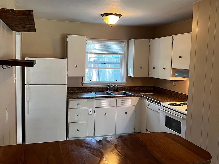 Nice eat in kitchen with small breakfast bar and appliances. New Refridge, stove and dishwasher.