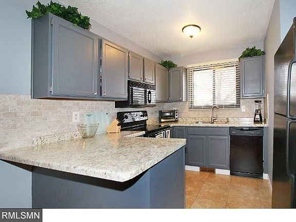 Updated kitchen with new counters, tile backsplash, sink, dishwasher, and ceiling fan