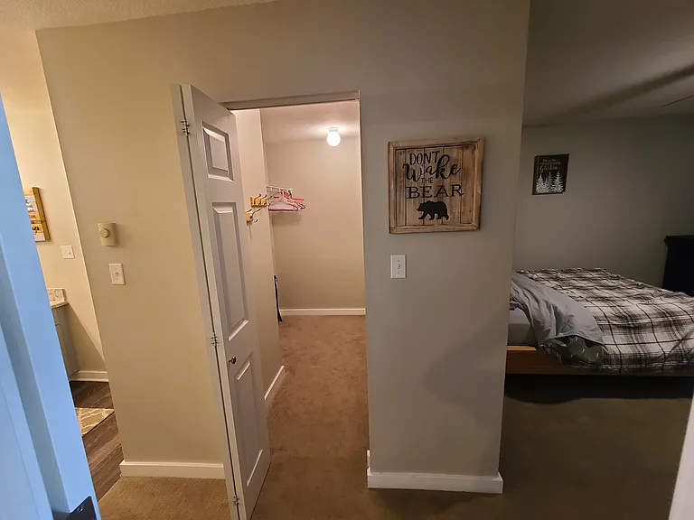 Roomy 2nd bedroom adjacent to large walk-in closet with portable bed and bathroom with double sinks