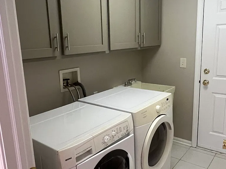 Laundry room with new cupboards.
