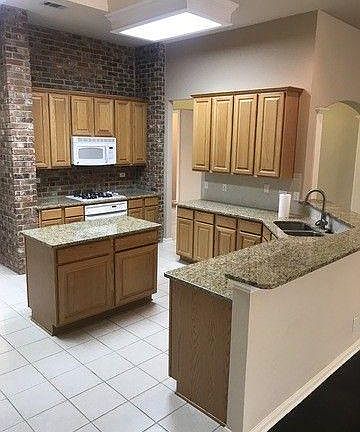 Kitchen with prep island and dining bar