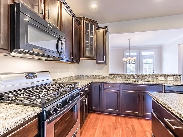 Gourmet kitchen with granite counter top with abundant oak cabinets for storage on 2nd floor