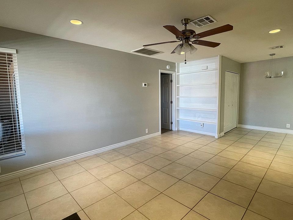 View inside front door. Living room to dining room to kitchen. Master bedroom door.