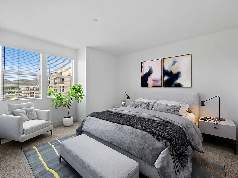 Brighten your space with a bedroom featuring large windows, bringing in natural light and stunning views.