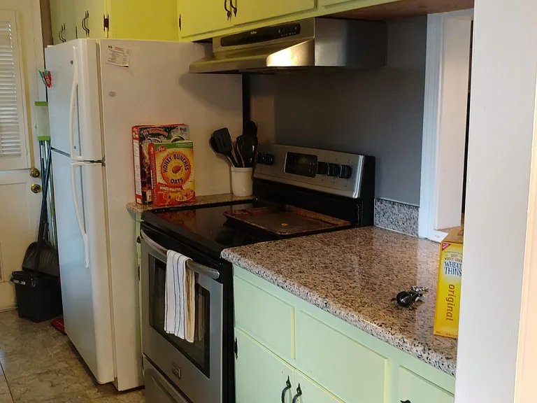 Kitchen with electric stove, granite counter top