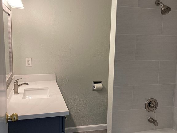 Main bathroom upstairs has new tile shower, new flooring, vanity and quartz countertop.