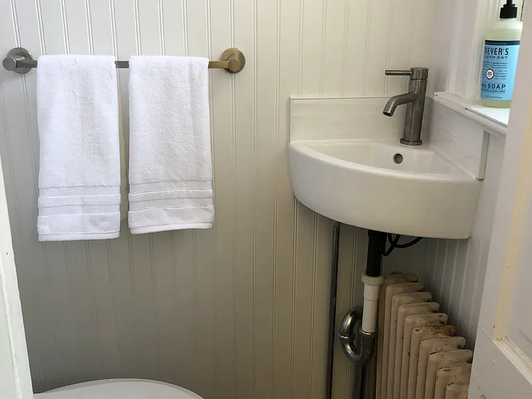 Newly renovated powder room around the corner from kitchen