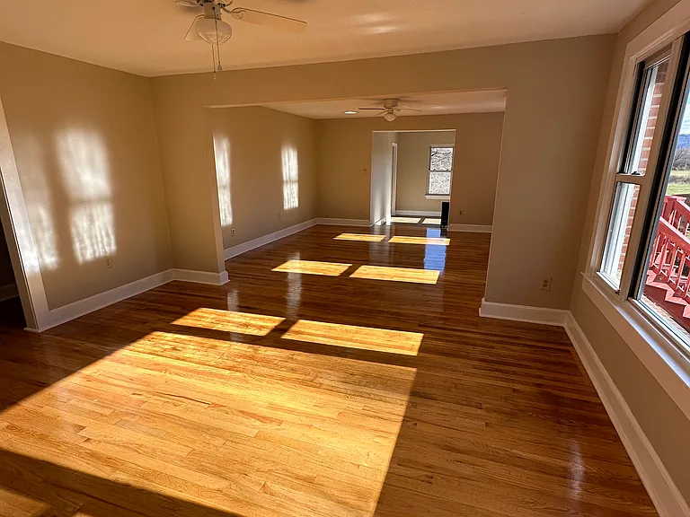 Different view of dining / living area. note the two ceiling fans.