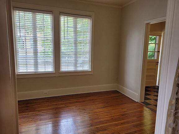 Living room with hardwood floor and tudor windows