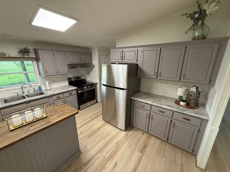 Kitchen with butcher block island, new countertops, and appliances