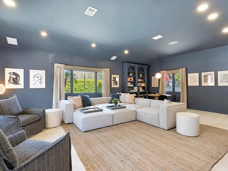 Deep seating sofa with trays for beverage placements.