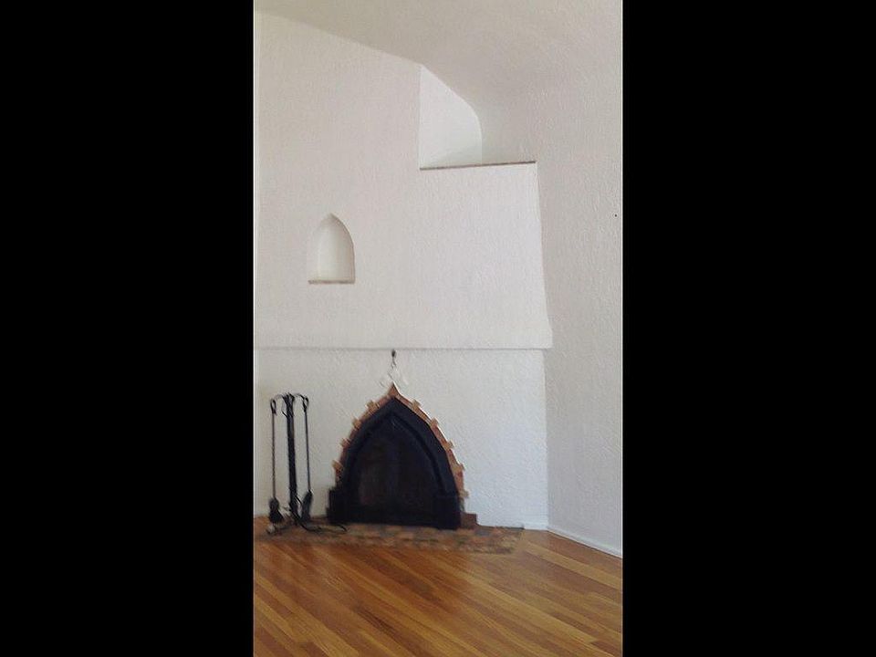 3. . Living room with vaulted ceiling, hardwood flooring, corner fireplace.d