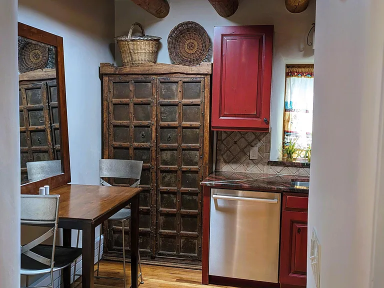 Mesquite pantry cabinet, dishwasher and solar tube lighting over kitchen dining nook