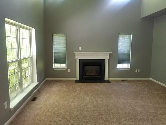 Den with gas fireplace off kitchen