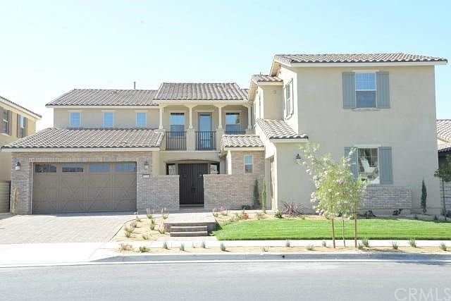 Fully landscaped front yard with pavers though out driveway and walkway to front door