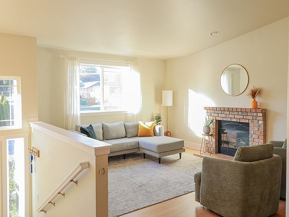 Bright living room with gas fireplace and vaulted ceilings! So cozy!