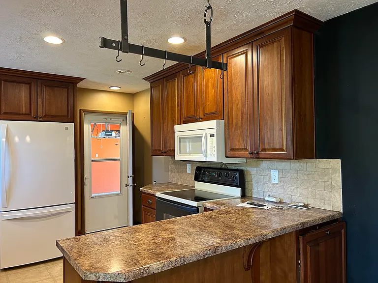 Kitchen door leads to attached garage