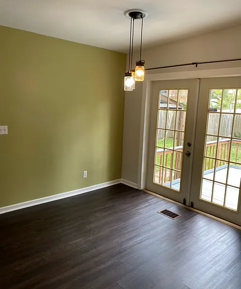 French doors lead to deck and backyard. (Draperies from previous photo removed for cleaning, but are included.