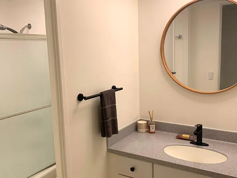 Bathroom has tub and shower.
