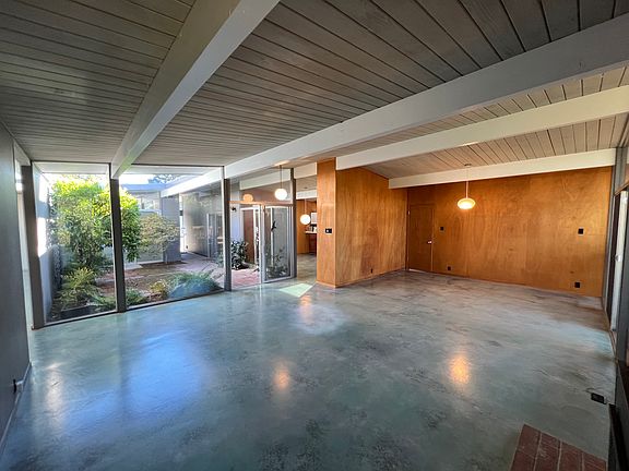 Living room and dining area, facing atrium and entry
