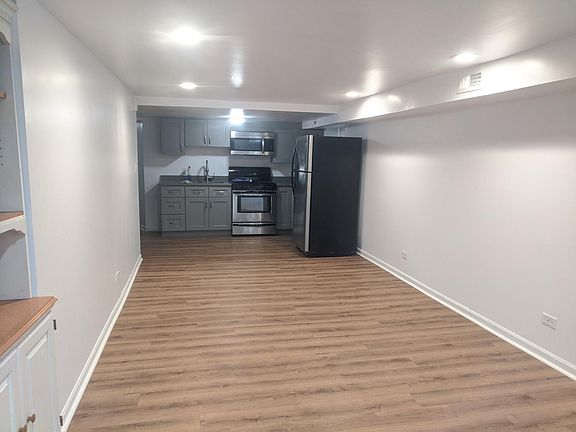 Open living space and kitchen (approx 12'x23' plus 6'x12' for kitchen). View from front window.