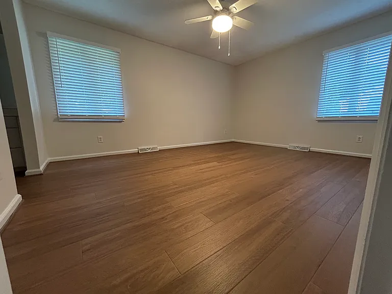 Master bedroom with new LVP, fresh paint and 2 in faux wood blinds