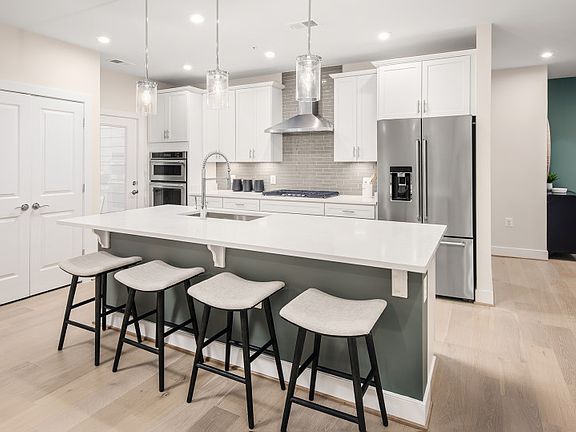Bright and Open Kitchen Featuring Quartz Countertops and Stainless Steel Appliances